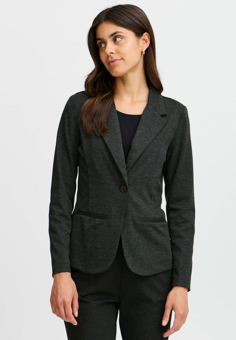 Dark gray blazer made of textured fabric, featuring a single button, notched lapels, and two front pockets. Worn over a black shirt.