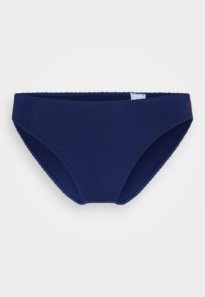 Navy blue bikini brief made of smooth fabric with scalloped edges. Features a small logo on the side and a classic cut.