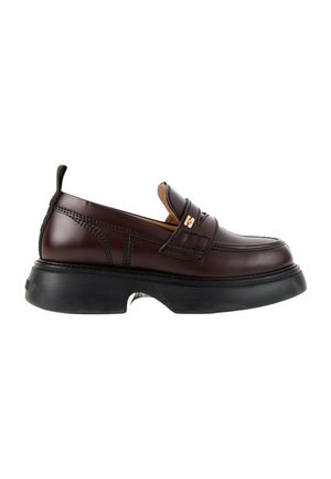Mocassin en cuir marron foncé avec semelle noire épaisse, petit logo doré sur la bride et languette au talon, vu de côté.