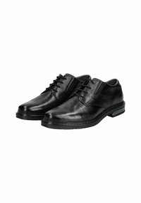 Zapatos de cuero negro con un acabado suave, punteras redondeadas y costuras decorativas. Cuentan con cordones y una suela de perfil bajo.