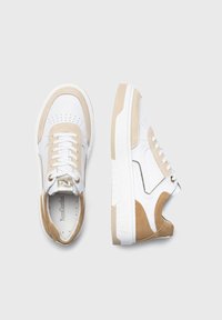 Sneakers bianche con accenti in suede beige, dettagli perforati e lacci rotondi. Presentano un colletto imbottito e una suola in gomma bianca testurizzata.