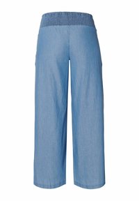 Light blue culotte pants with a stretchy smocked waistband and wide legs, made of soft denim fabric. No visible pockets or patterns.