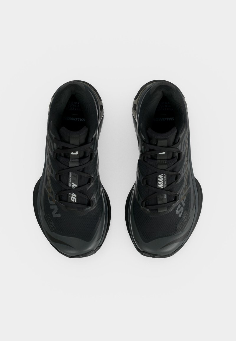Pair of black Salomon athletic shoes with lace-up closure, visible branding, and a sturdy sole, viewed from above on a white background.
