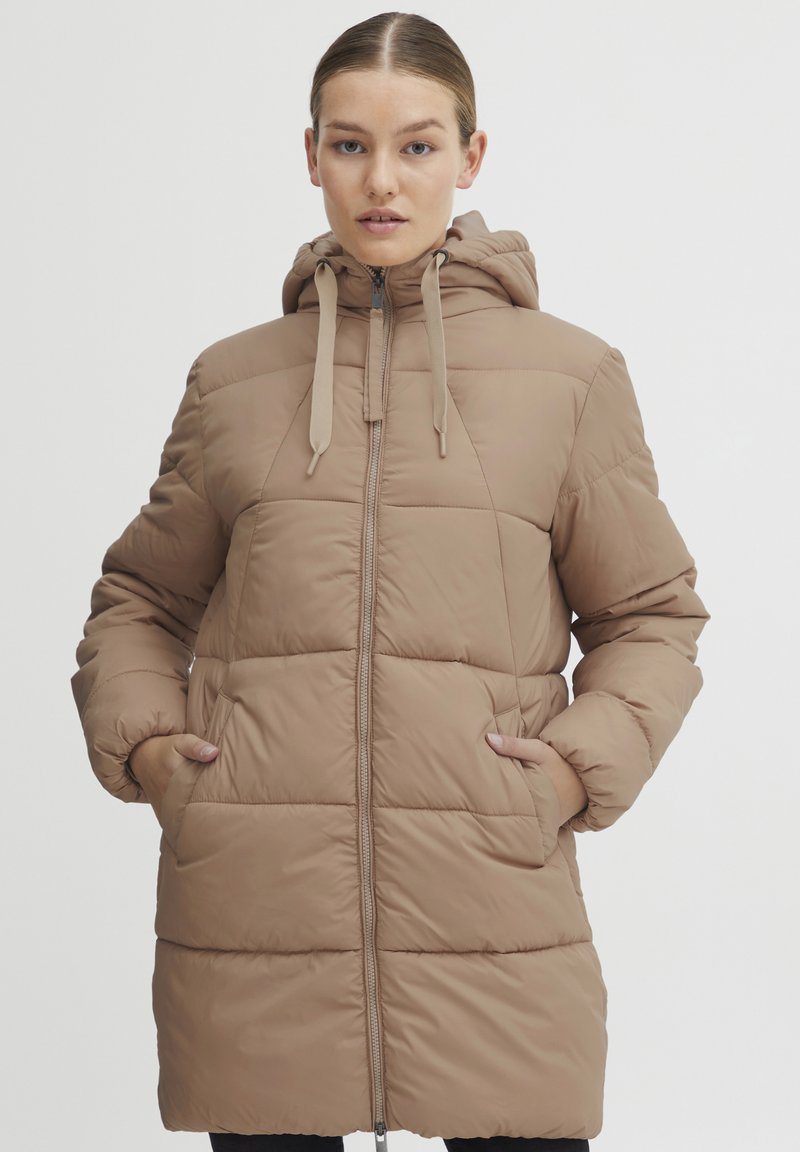 Beige puffer coat with a hood, featuring a central zipper, textured diamond quilt pattern, and side pockets for functionality.