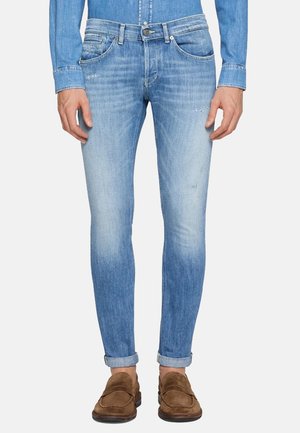 Jeans in denim blu chiaro con vestibilità slim, lavaggio sbiadito e lievi segni di usura. Accentuati da tasche classiche e design con passanti per cintura.