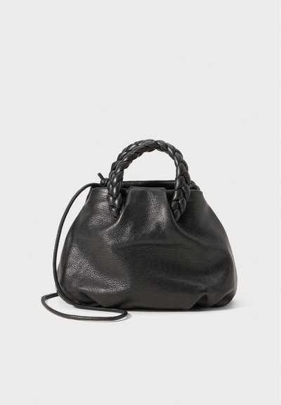 Black leather handbag with braided handles, soft texture, round shape, and an adjustable shoulder strap. Simple, unembellished design.
