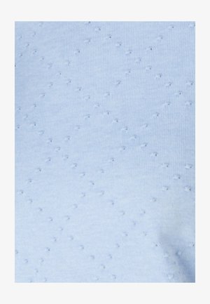 Tessuto azzurro chiaro con un motivo testurizzato di punti in rilievo. Il materiale appare morbido e leggermente elasticizzato, adatto per abbigliamento casual.