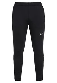 Zwarte sportbroek gemaakt van gladde stof met een aansluitend ontwerp, een elastische tailleband en een klein wit Nike-logo op de linker dij.