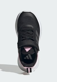 Black athletic shoe with mesh upper, synthetic accents, pink detailing, hook-and-loop strap, and white sole. Features three stripes logo.