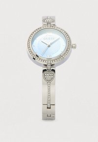 Sølv ur i metal med rund urskive, blå mønstret skive, krystaldekorationer rundt om rammen og et hjerte detaljer på armbåndet.