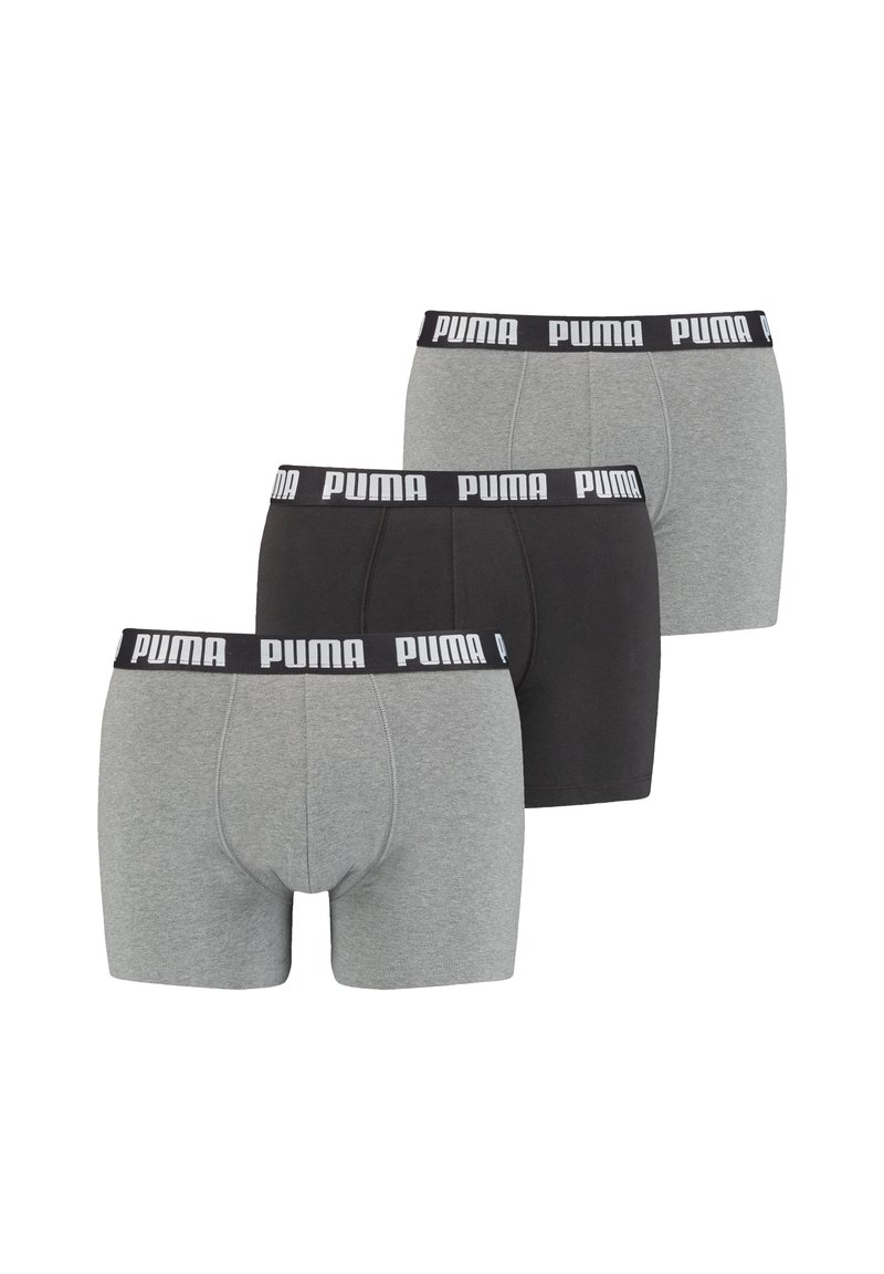 Three pairs of men's boxer briefs. One gray with black waistband, one black with white logo waistband, and another light gray with similar waistband.