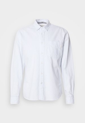 Camicia bianca a maniche lunghe con righe verticali azzurre. Design con bottoni, dotata di una tasca sul petto e di una piccola etichetta del marchio sulla tasca.