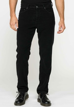 Jeans in denim nero con vestibilità slim, design a cinque tasche e zip. Completati con accessori metallici e cuciture a contrasto sulle tasche.