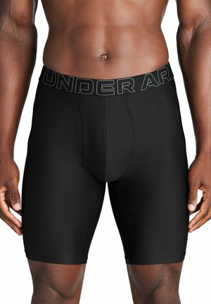 Svarta kompressionsshorts tillverkade av ett slätt, elastiskt material med ett brett elastiskt midjeband som har "UNDER ARMOUR"-logotypen.