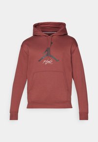Felpa atletica rossa con cappuccio a kangaroo, cappuccio regolabile con stringa e un logo Jumpman nero con il testo "Flight" in bianco sulla parte anteriore.