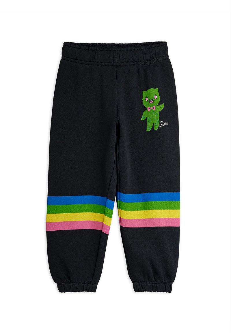 Μαύρα παιδικά παντελόνια φόρμας με ελαστική μέση και μανσέτες, διακοσμημένα με πολύχρωμες οριζόντιες ρίγες και μικρό πράσινο καρτούν χαρακτήρα με ροζ φιόγκο.