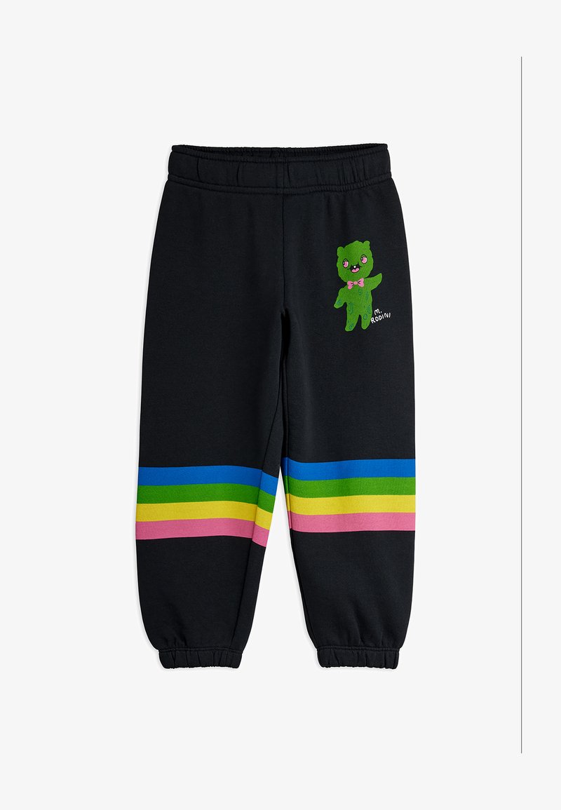 Μαύρα παιδικά παντελόνια φόρμας με ελαστική μέση και μανσέτες, διακοσμημένα με πολύχρωμες οριζόντιες ρίγες και μικρό πράσινο καρτούν χαρακτήρα με ροζ φιόγκο.
