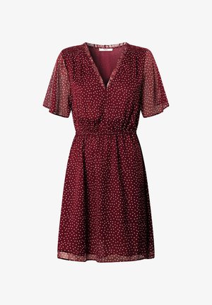Vestito bordeaux a pois con maniche corte arricciate, scollo a V e cintura elastica, realizzato in tessuto leggero e trasparente.