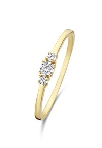Gold ring featuring three clear round diamonds in a delicate claw setting, with a smooth, polished band.