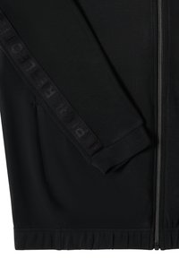 Giacca nera con zip in tessuto testurizzato. Presenta una fascia nera a contrasto lungo la manica con testo in rilievo e polsini ed orlo elasticizzati.