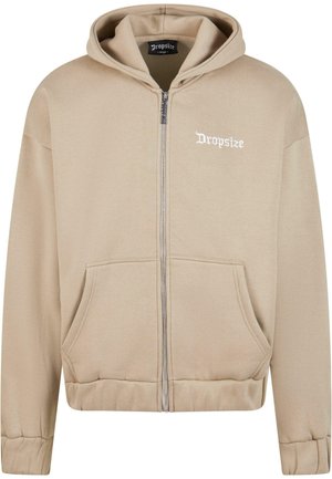 Beige zip-up hoodie with a drawstring hood, front pockets, ribbed cuffs, and hem. Features "Dropsize" text in white on the chest.