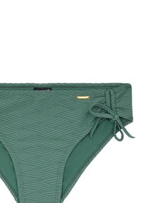 Žalioji bikinių apatinė dalis, pasižyminti tekstūriniu herringbone raštu, su papildomu raišteliu šone ir mažu metaliniu logotipu.