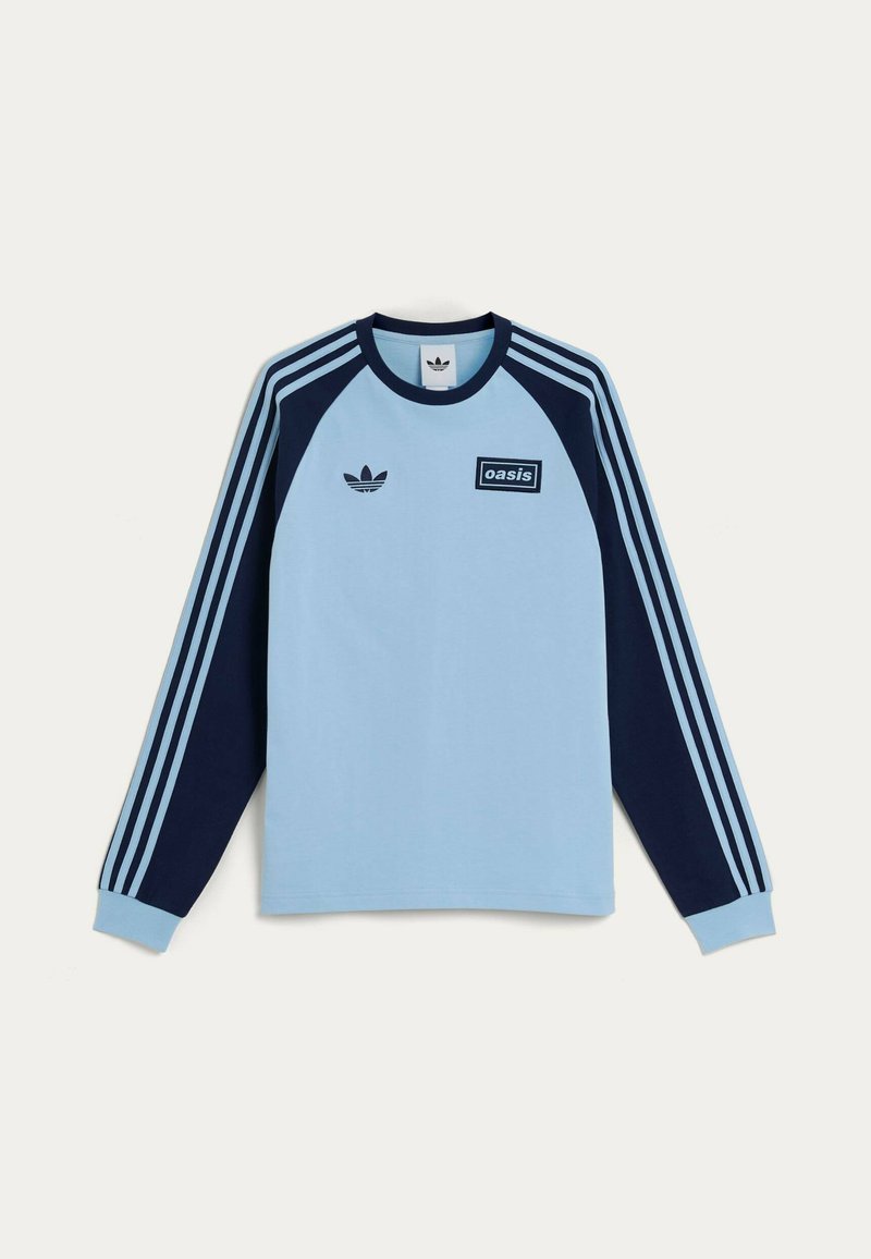 Camicia azzurro chiaro a maniche lunghe con dettagli blu navy, dotata di un logo stampato e tre strisce sulle maniche. Materiale misto cotone.