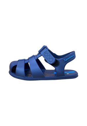 Sandalia infantil de goma azul marino con tres tiras delanteras, tira ajustable de velcro y marca "Ipanema" en la correa del talón.