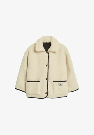 Cremfarbener Kunstfell-Jacke mit Kragen, schwarzem Besatz, vorderem Druckknopfverschluss und zwei großen aufgesetzten Taschen.