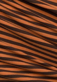 Ribbed fabric with horizontal stripes in burnt orange and dark brown. Texture is soft with visible stretch and depth from the folding.