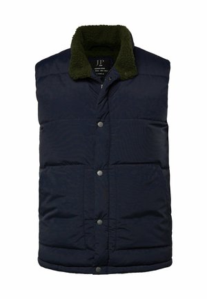Donkerblauwe puffer vest met groene fleece kraag, voorzien van drukknoopsluiting en twee voorkgzakken. Zachte, gewatteerde textuur.