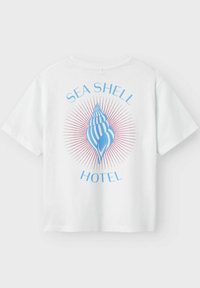 Witte katoenen t-shirt met een blauw schelpenprint en de tekst "SEA SHELL HOTEL" en een rode zonnestraalontwerp op de rug. Korte mouwen.