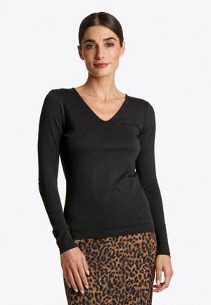Black long-sleeve t-shirt with a V-neck design, made from soft fabric, featuring a slim fit and smooth texture, paired with a leopard print skirt.