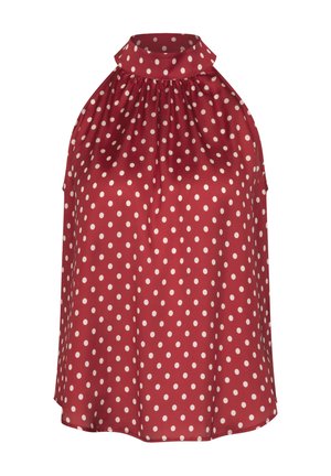 Haut rouge sans manches à col licou avec des pois blancs et un col montant froncé.