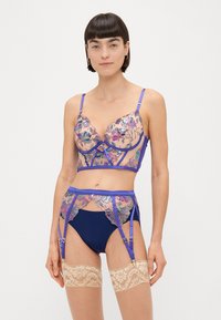 Sutien și set de ciorapi cu dantelă în nuanță de navy, având broderie florală în accente de mov, roz și argintiu. Setul include ciorapi cu dantelă pe partea de sus.