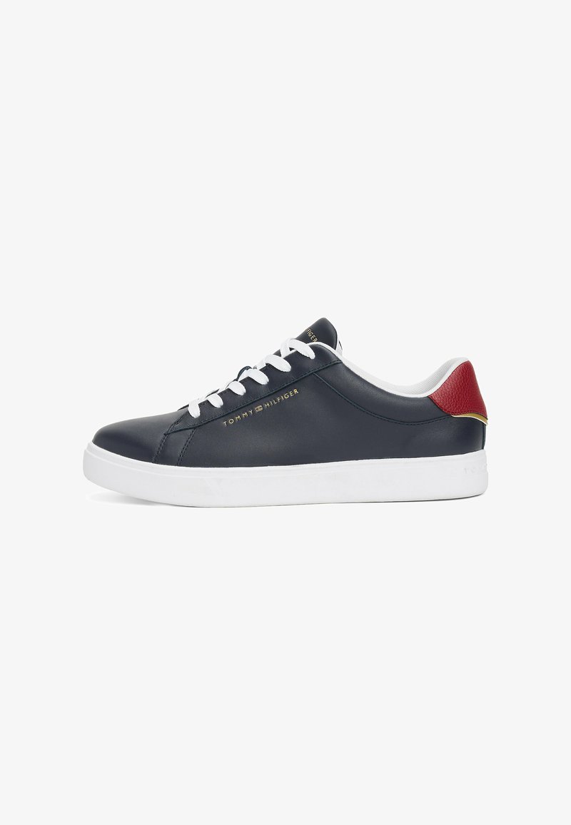 Navy leather sneakers with white laces and rubber sole. Red accent at the heel and gold logo on the side, featuring a smooth texture.