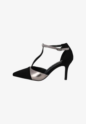 Black and metallic silver pointed-toe high-heel shoe with T-strap design, suede material, and smooth leather accent.