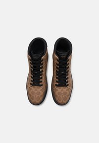 Bruine hoogtop sneakers met een patroon, zwarte veters en een zwarte kraag. Heeft een logo op de tong en een gestructureerde stof aan de bovenkant.