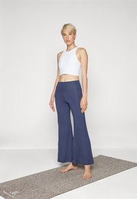 Yogasearcher JAIPUR FLARE PANTS - Tracksuit bottoms - navy