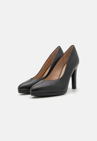 Black leather high-heeled shoes with a pointed toe design and smooth texture, featuring a modest platform and a sleek stiletto heel.