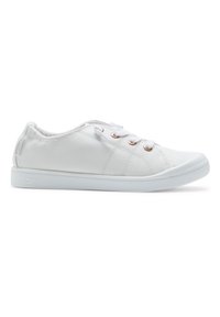 Hvit sneaker med et teksturert stoffoverdel, rund tå og lys rosa snøringer. Har en flat hvit gummi såle og en liten logo på siden.