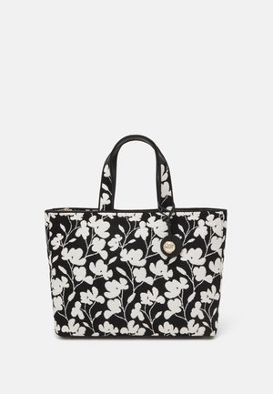Sac tote noir avec broderie florale blanche, poignées robustes, matériel à bouton et finition texturée. Convient à un usage quotidien.