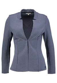 Námorně modrý blazer s texturovaným vzorem, otevřeným předním dílem, dlouhými rukávy a síťovanou podšívkou pro ventilaci. Má přiléhavý siluetu.