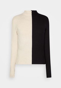 Rippstrick-Turtleneck-Pullover mit einem geteilten Design in Creme und Schwarz. Lange Ärmel, strukturierten Stoff und einen hohen Kragen.