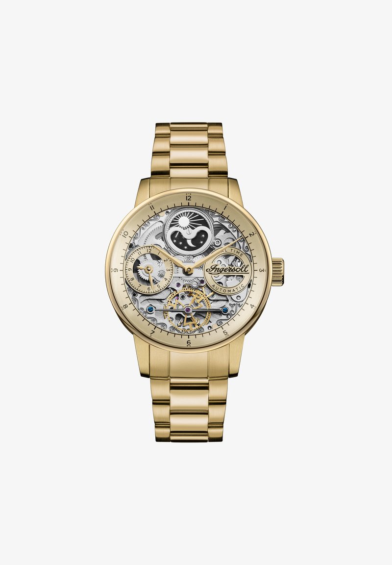 Gouden horloge met een skeletdial die ingewikkelde mechanische onderdelen, twee sub-dials en een geschakelde metalen armband toont.