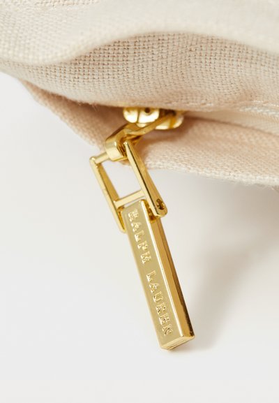 Beige fabric pouch with a gold zipper pull featuring "RALPH LAUREN" engraved on the side, showcasing a textured surface and sleek design.
