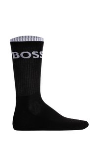 Black sock with a ribbed white cuff, featuring the brand name "BOSS" prominently in white lettering on the side. Smooth texture.