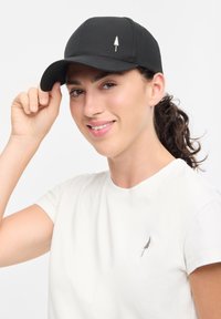 Black cap with a rounded crown and curved brim, featuring a small white tree logo on the front panel. Smooth fabric texture.