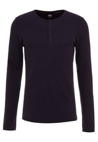 Long-sleeve, dark purple henley shirt made of textured fabric, featuring a crew neck, three buttons at the collar, and a fitted design.