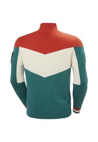 Sweter wełniany w kolorze głębokiego niebieskiego, białym i pomarańczowym, z wzorem w zygzak, wysokim kołnierzem, ściągaczami na rękawach oraz okrągłą naszywką na lewym rękawie.